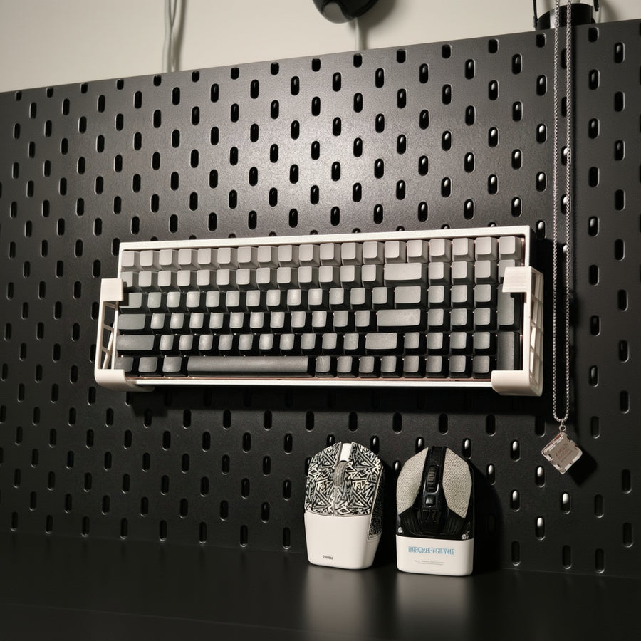 Mechanical keyboard on a black pegboard with tools below