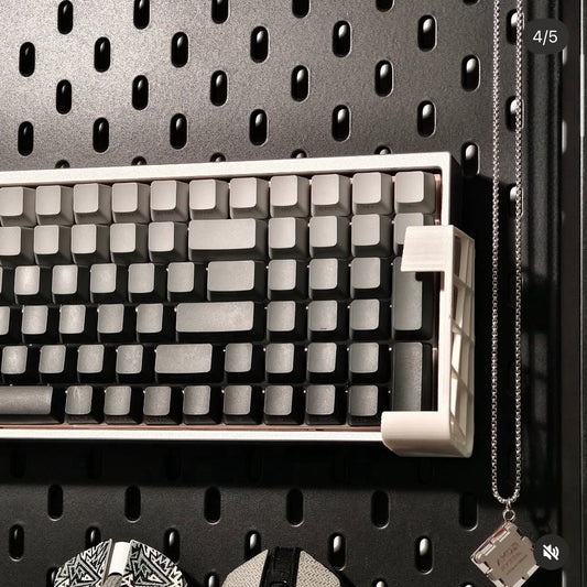 Mechanical keyboard on a pegboard with various items